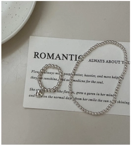 Detail of S925 sterling silver beaded ring and bracelet set with heart charm pendant