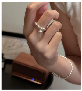 Detail of S925 sterling silver beaded ring and bracelet set with heart charm pendant
