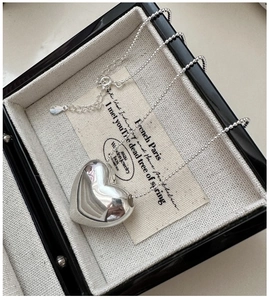Detail of S925 silver heart pendant necklace with elegant snake chain in jewelry box