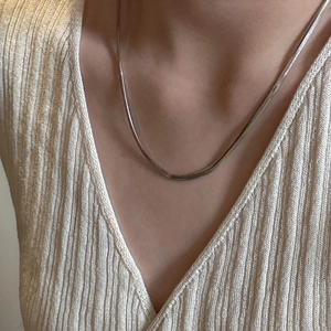 S925 sterling silver flat snake bone chain necklace shown on neck for minimalist styling