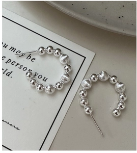 Detailed close-up of S925 sterling silver C-shaped beaded earrings with matte finish
