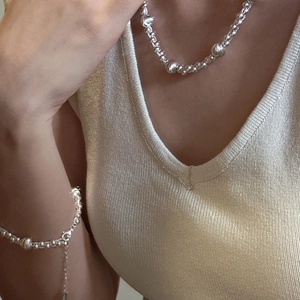 Minimalist S925 sterling silver beaded necklace and bracelet set worn by a model