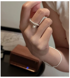 Close-up of S925 sterling silver beaded ring with heart pendant and matching bracelet