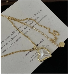 Detail of S925 sterling silver heart pendant necklace with gold frame and white core