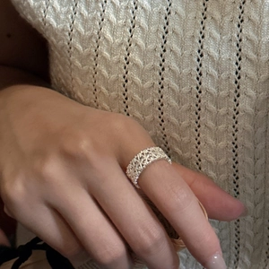 S925 sterling silver ring with intricate lace weave pattern on a female finger