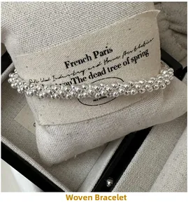 Detailed view of S925 sterling silver beaded wrap bracelet on a jewelry display cushion