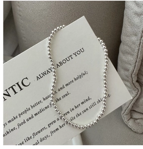 Close-up of S925 sterling silver beaded ring on a white card with elegant metallic luster