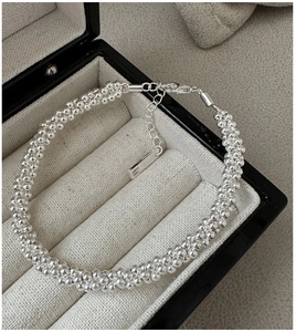 Close-up of S925 sterling silver triple beaded bracelet with lobster clasp in a jewelry box