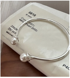 Close-up of S925 sterling silver cuff bracelet with 8mm white pearl double heads