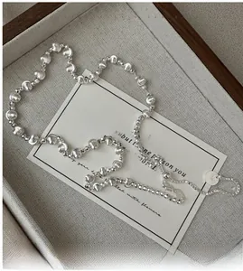 Detailed close-up of S925 sterling silver beaded necklace with adjustable clasp and tag