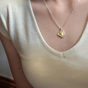 Minimalist 925 sterling silver heart necklace with gold and silver contrast on neck