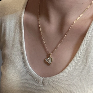 925 silver heart necklace with gold chain and white shell inlay worn by model
