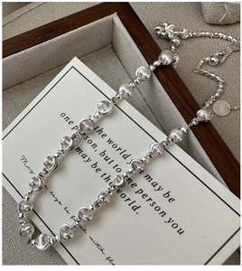 Macro detail of S925 sterling silver beaded necklace showing S925 hallmark and textures