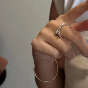 S925 sterling silver beaded ring featuring a polished heart pendant on a hand