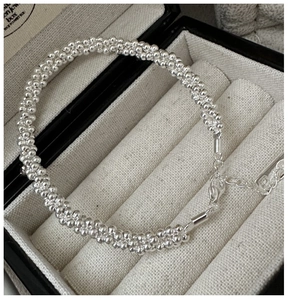 Detailed macro view of S925 sterling silver beaded bracelet with lobster clasp in gift box