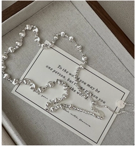 Detail of S925 sterling silver cat eye bead necklace with adjustable sliding chain on a card
