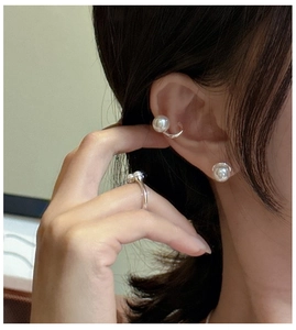Close-up of elegant S925 silver pearl ring and earring set worn by a model