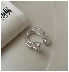 Close-up of a double-layered S925 silver ring featuring four white faux pearls in a modern design