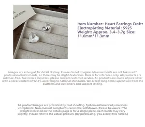Detail showing S925 sterling silver heart earrings measuring 11.6mm with polished finish