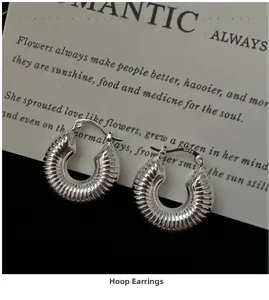 Close-up of S925 sterling silver hoop earrings with spiral texture and hallmark stamp