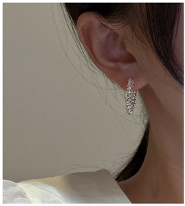 Macro shot of S925 sterling silver hoop earrings with a textured lava finish on ear