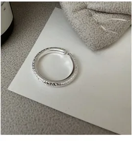 Macro shot of S925 sterling silver ring with unique hammered texture on white card