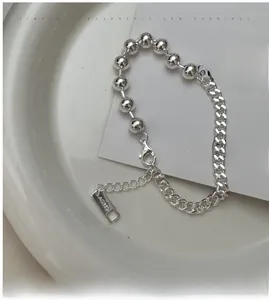 Detailed macro view of S925 sterling silver bead and Cuban link chain bracelet