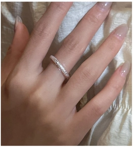 Close-up of S925 sterling silver ring with shimmering textured finish on model finger