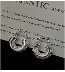 Close-up of S925 sterling silver stamp on minimalist ribbed croissant hoop earrings
