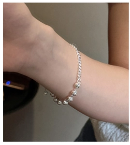 Detailed close-up of S925 sterling silver beaded bracelet with polished metallic luster