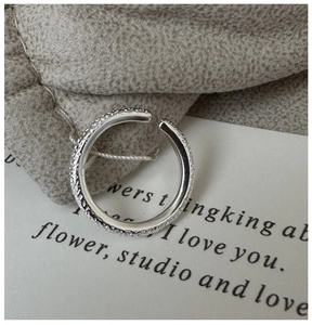 Close-up of S925 sterling silver ring featuring a unique hammered texture and industrial design