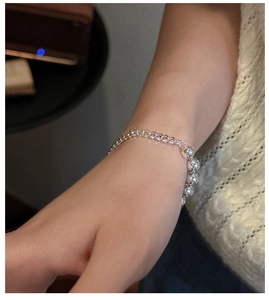 Close-up of S925 sterling silver bracelet featuring bead stitching and polished chain