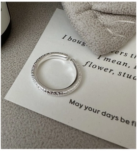 Macro shot of S925 sterling silver ring with unique hammered lava texture and open design