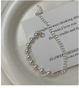 Detailed macro of S925 sterling silver beaded chain bracelet with adjustable lobster clasp