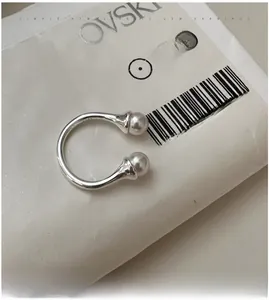 Close-up of S925 sterling silver open ring featuring two elegant white pearls