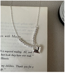 Detail of S925 sterling silver necklace featuring laser beads and a polished heart pendant
