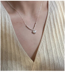 Close-up of S925 sterling silver heart pendant necklace with laser beads on neck