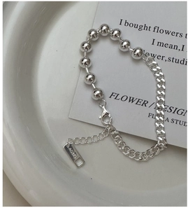 Macro shot of S925 sterling silver beaded chain with lobster clasp and AG925 tag