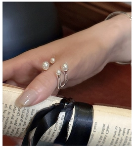 Elegantly styled silver S925 pearl ring worn by a model against a vintage background