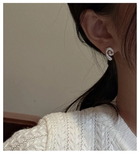 Close-up of elegant S925 sterling silver shell textured stud earring on a female model