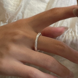 Minimalist S925 sterling silver ring with unique hammered rock texture on finger