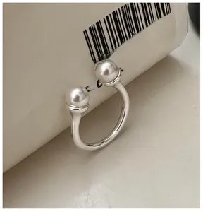 Close-up of S925 sterling silver ring showing the hallmark stamp and dual pearls