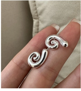 Close-up of polished S925 sterling silver conch earrings with minimalist spiral design