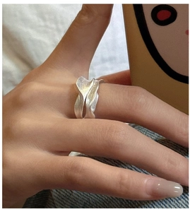 Close-up of S925 sterling silver ring featuring a matte textured irregular wavy design