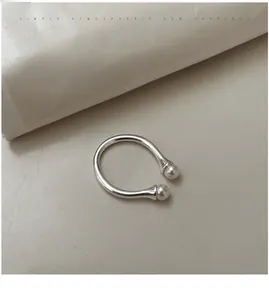 Detail of S925 silver open ring featuring double white pearls in a minimalist design