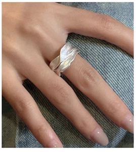 Detail of S925 sterling silver ring featuring irregular wave texture and matte finish