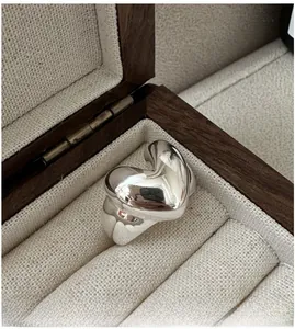 Macro shot of polished S925 sterling silver heart-shaped ring in a luxury jewelry box