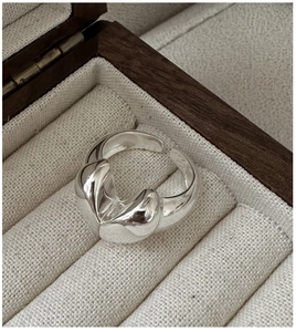 Macro shot of silver heart-shaped adjustable ring in a wooden velvet jewelry box