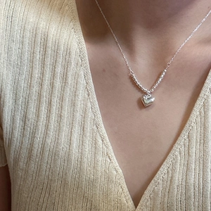 Elegant S925 sterling silver heart pendant necklace on model with bead chain details