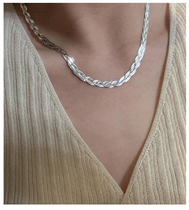 Close-up of S925 sterling silver triple braided necklace worn on a V-neck shirt